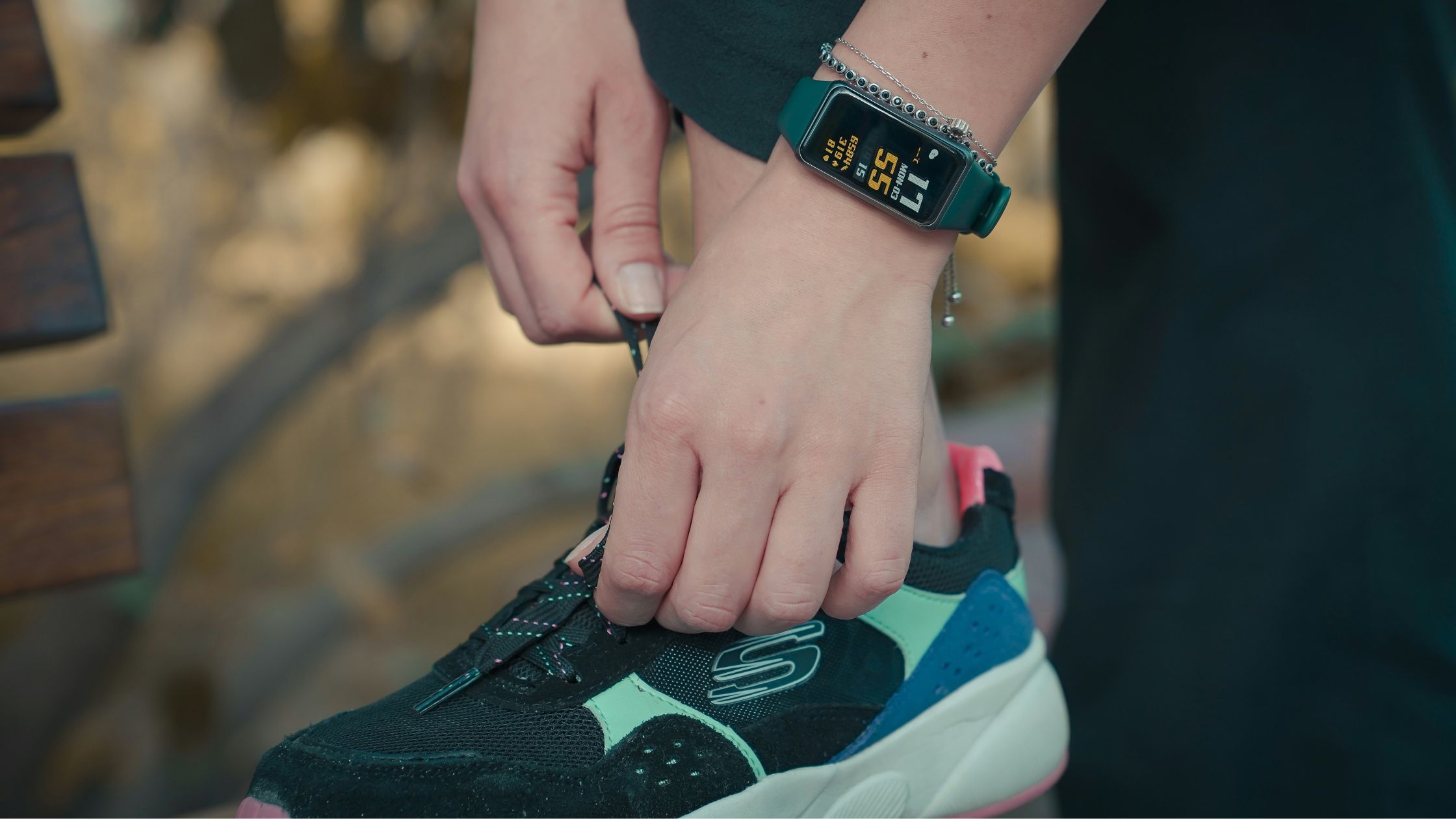 tying running shoes and using a fitness tracker